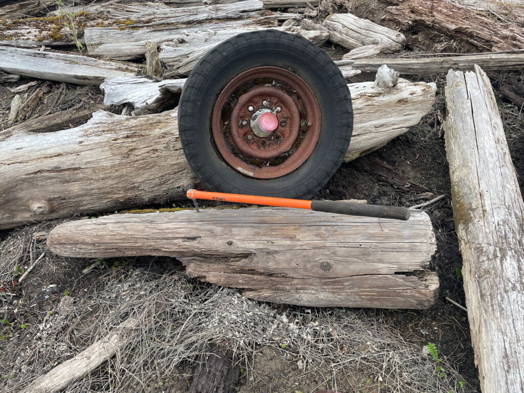 a wooden wheelbarrow with a stick and a shovel (MyCoast AI)