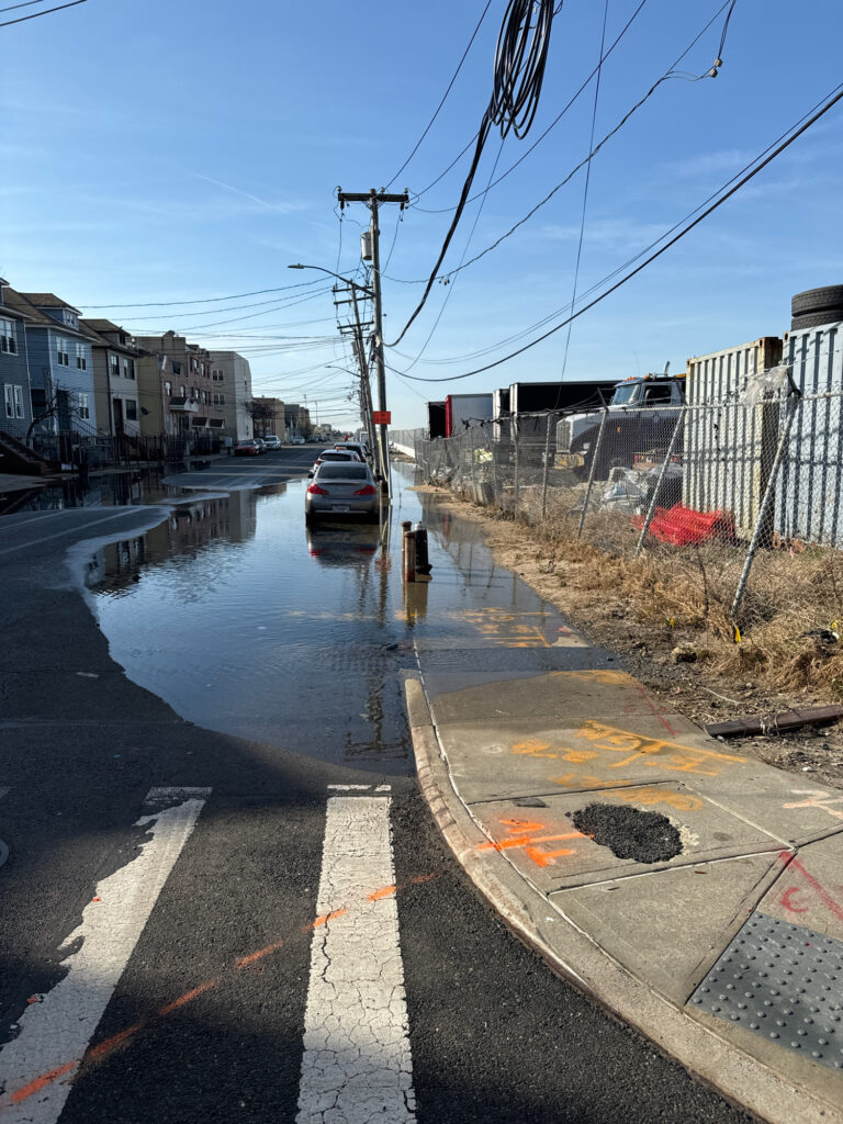 a flooded street with a car parked on the side (MyCoast AI)