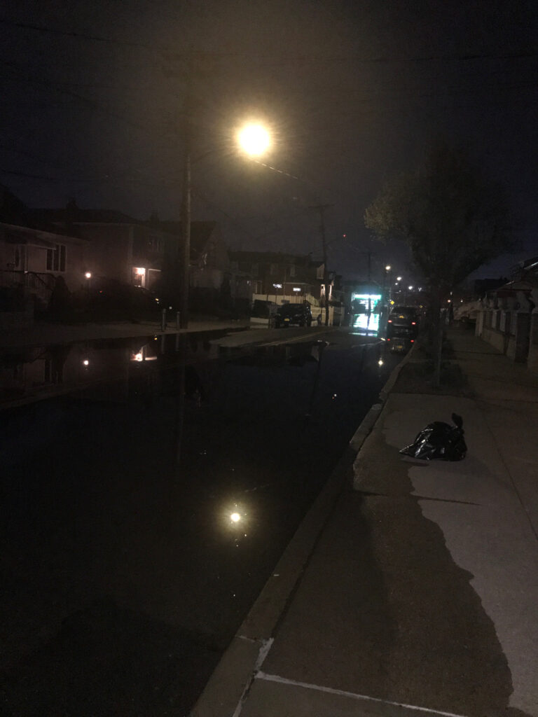 a person lying on the ground by a street at night (MyCoast AI)