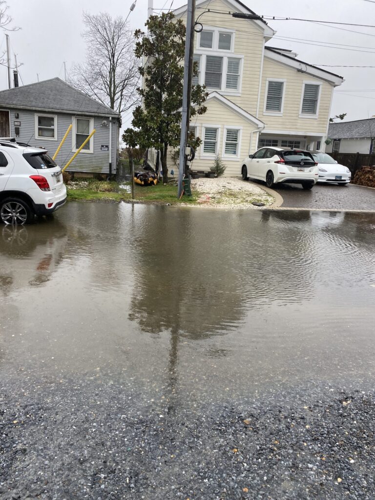 a flooded street with cars parked on the side (MyCoast AI)