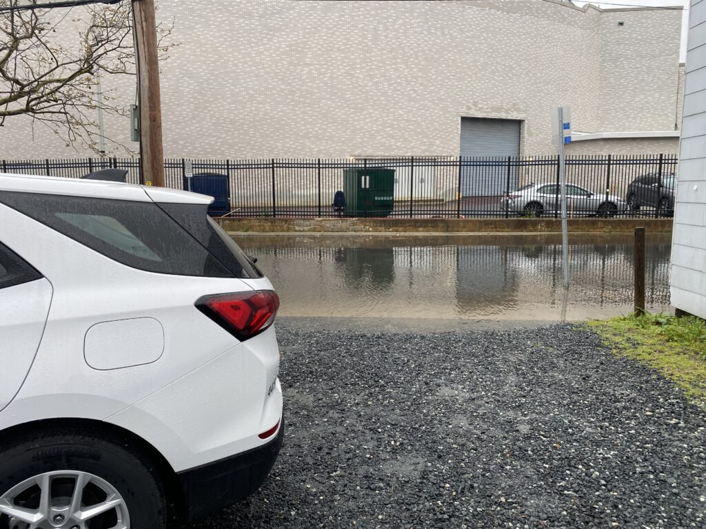 a white car parked in front of a building (MyCoast AI)