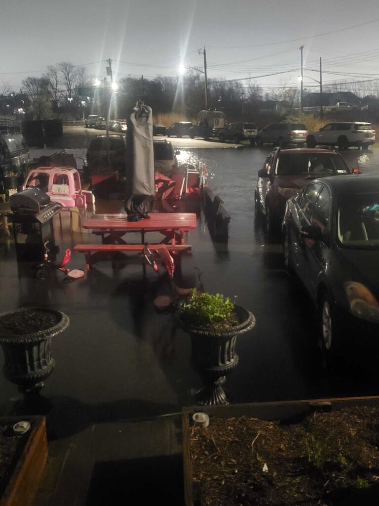 a group of cars parked on a street with a boat in the middle (MyCoast AI)