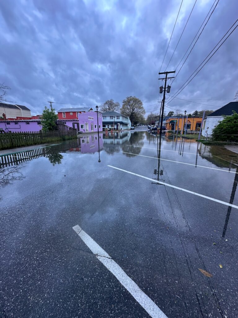 a flooded street with buildings and power lines (MyCoast AI)