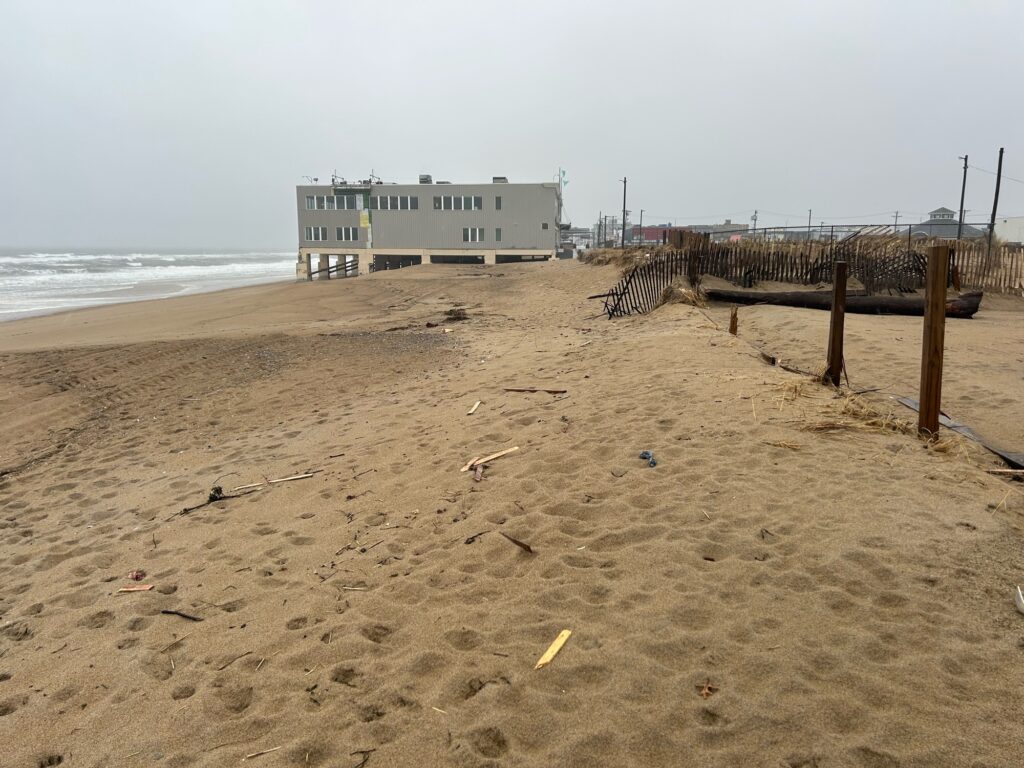 a beach with a building in the background (MyCoast AI)