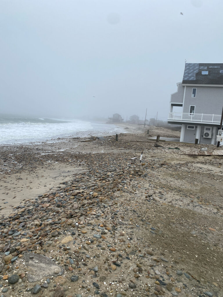 a rocky beach with a house (MyCoast AI)