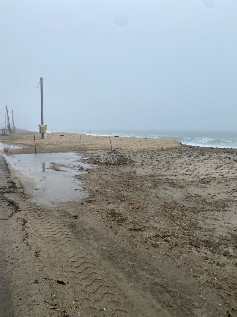 a sandy beach with a fence (MyCoast AI)