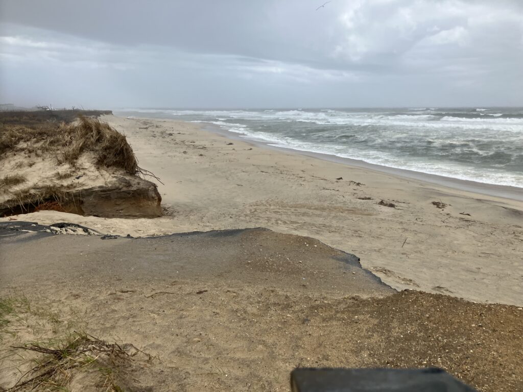 a sandy beach with waves crashing on it (MyCoast AI)