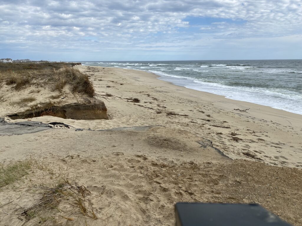 a sandy beach with rocks and water (MyCoast AI)