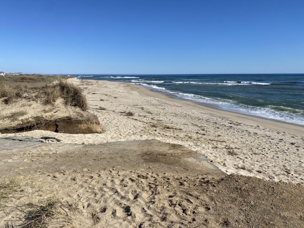 a sandy beach with waves crashing (MyCoast AI)