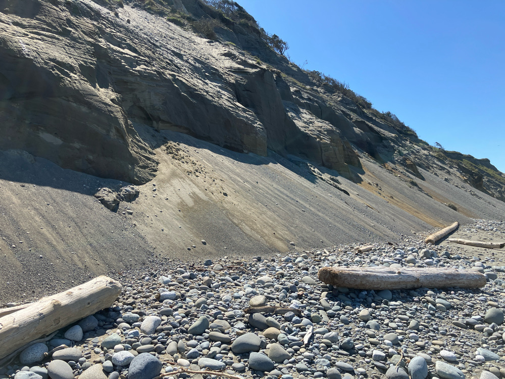 a rocky beach with a large rocky cliff (MyCoast AI)