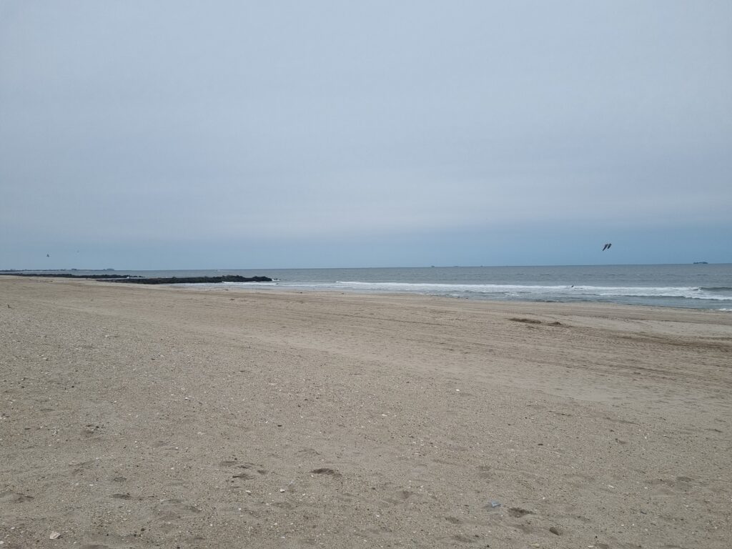 a sandy beach with waves crashing (MyCoast AI)