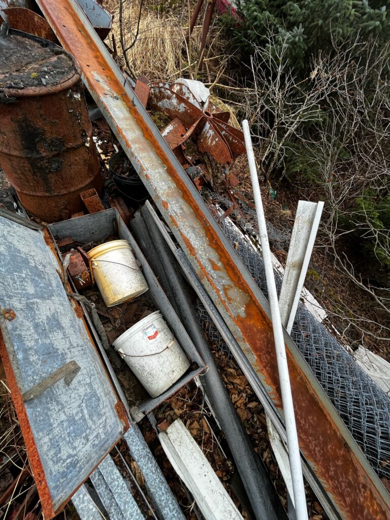 a pile of dirt and metal pipes (MyCoast AI)