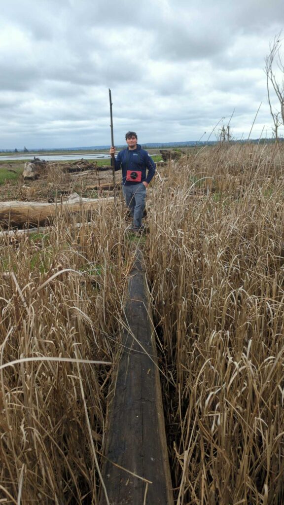 a person standing on a post in a field (MyCoast AI)