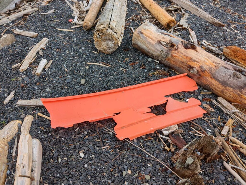 a red plastic knife on the ground (MyCoast AI)