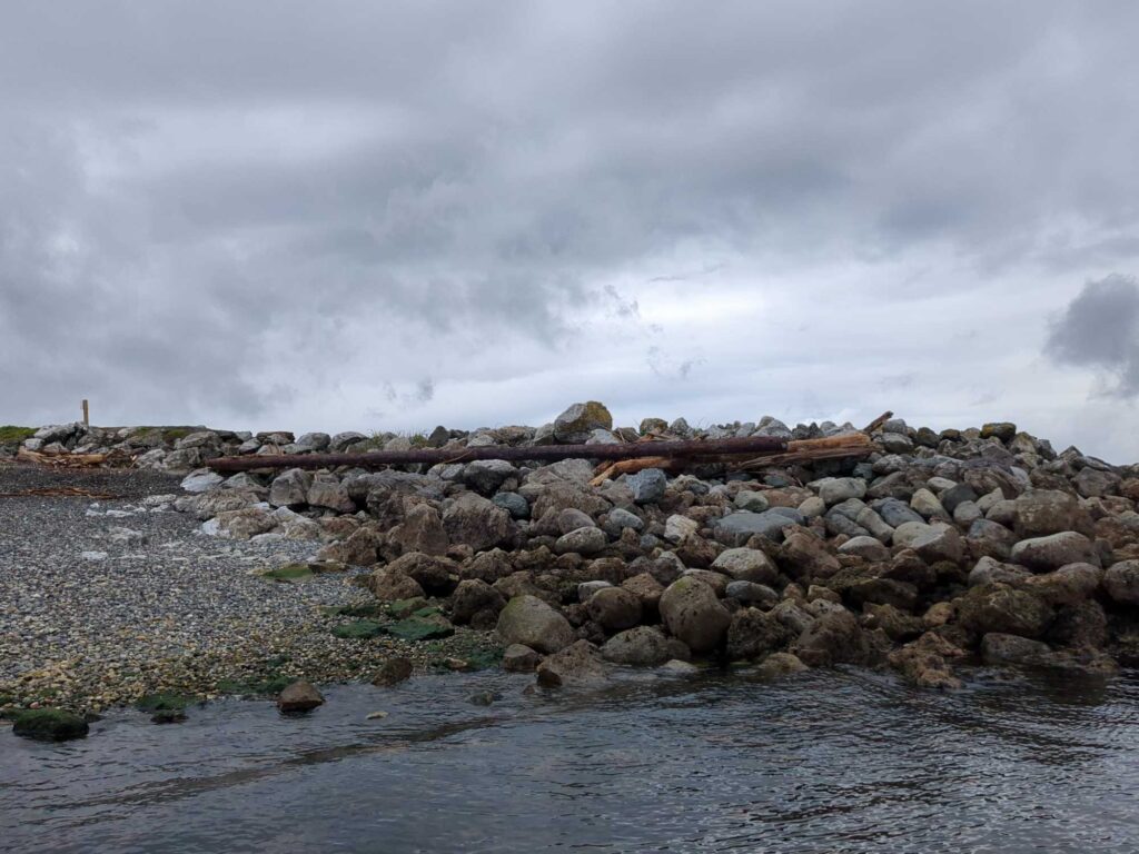 a rocky beach with a body of water in the background (MyCoast AI)