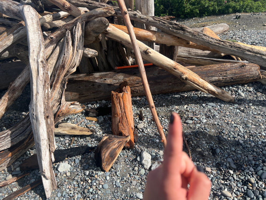 a hand holding a wooden cross (MyCoast AI)