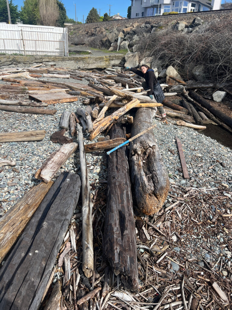 a person standing next to a pile of wood (MyCoast AI)