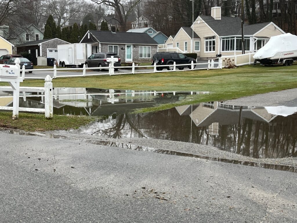 a flooded street with houses and cars (MyCoast AI)