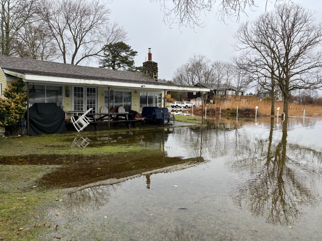a flooded house with a car parked in front of it (MyCoast AI)