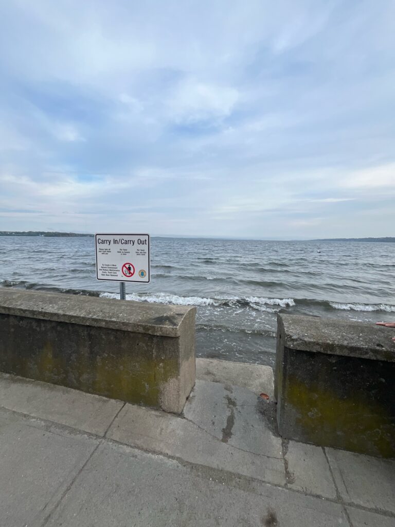 a sign on a wall by the water (MyCoast AI)