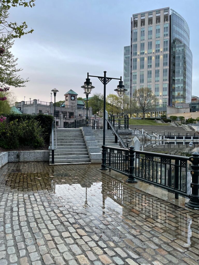 a stone walkway with a stone walkway and buildings in the background (MyCoast AI)