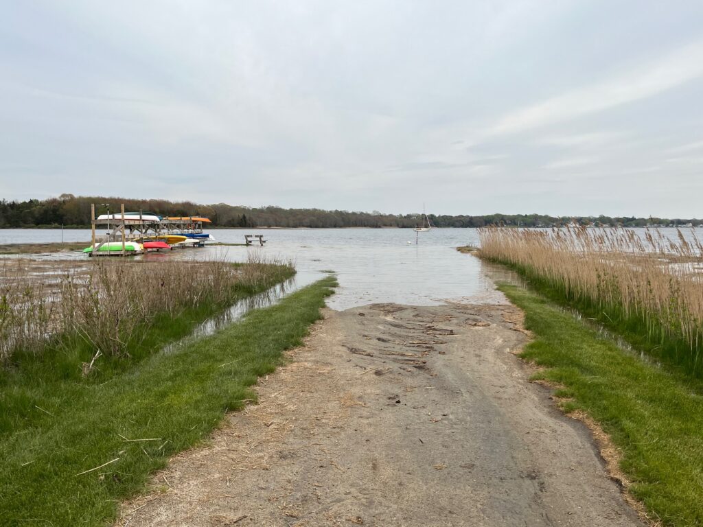 a path next to a body of water with boats in it (MyCoast AI)