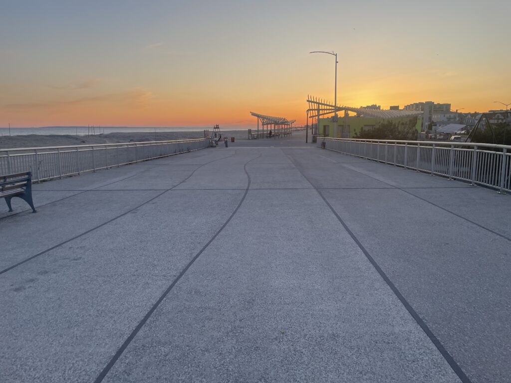 a walkway with benches and a body of water in the background (MyCoast AI)