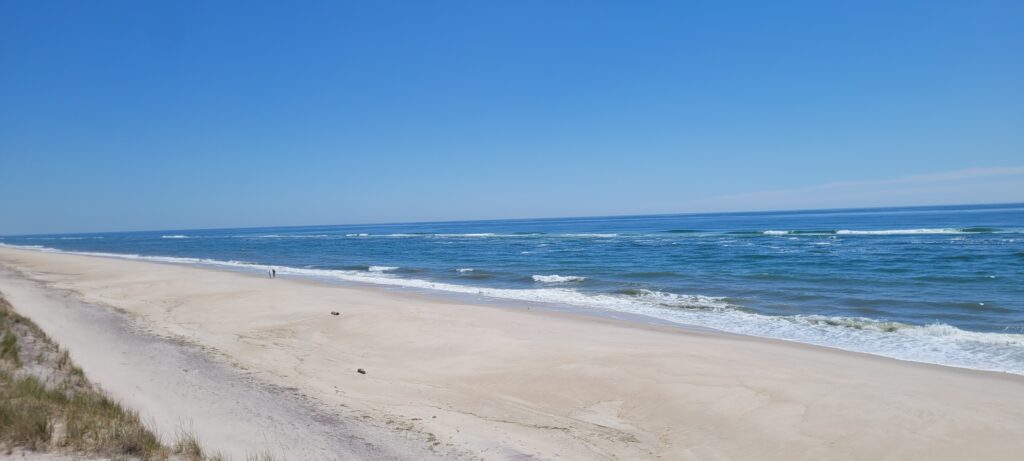a sandy beach with waves crashing on it (MyCoast AI)