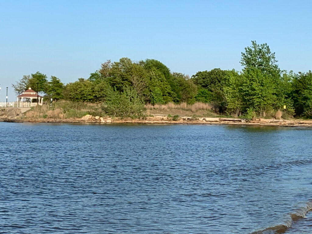 a body of water with trees and a house in the background (MyCoast AI)