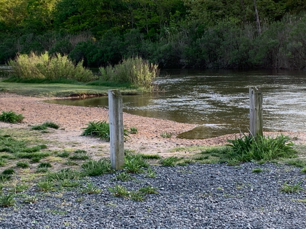 a river with a fence and trees (MyCoast AI)