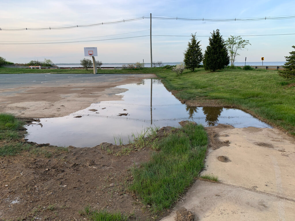 a flooded road with a puddle (MyCoast AI)