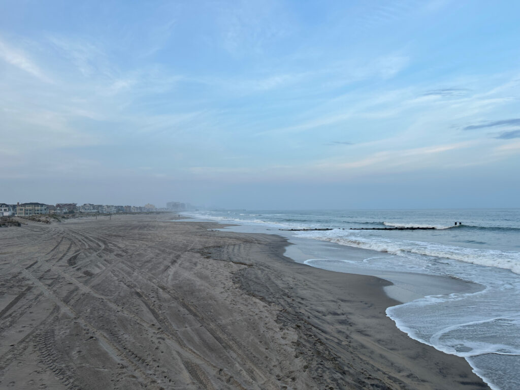 a sandy beach with waves crashing on it (MyCoast AI)