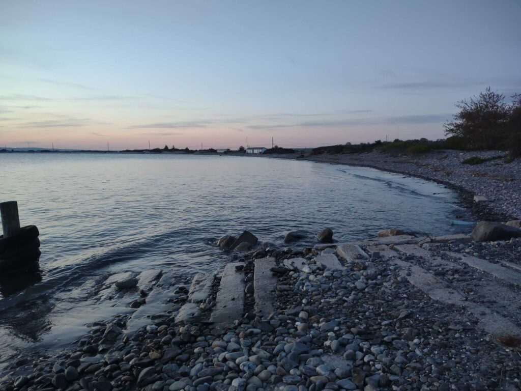 a rocky beach with a body of water in the background (MyCoast AI)