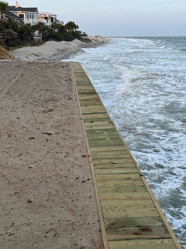 a beach with a long wooden fence (MyCoast AI)