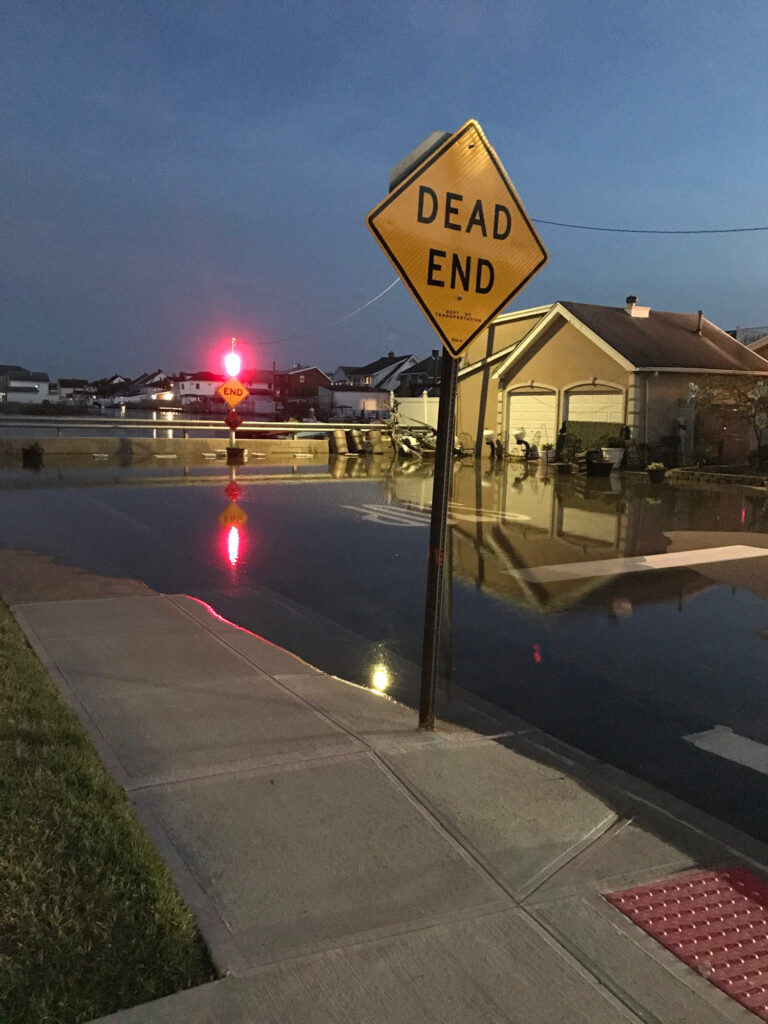 a yellow sign on the street (MyCoast AI)