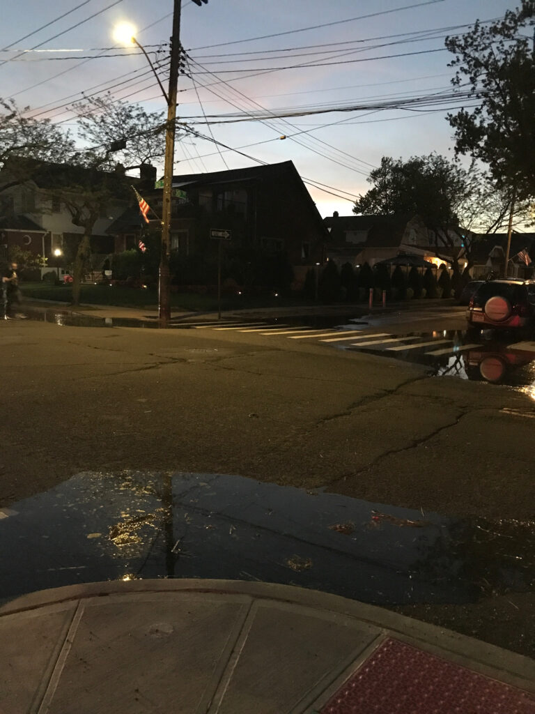 a street with a light pole and buildings on the side (MyCoast AI)