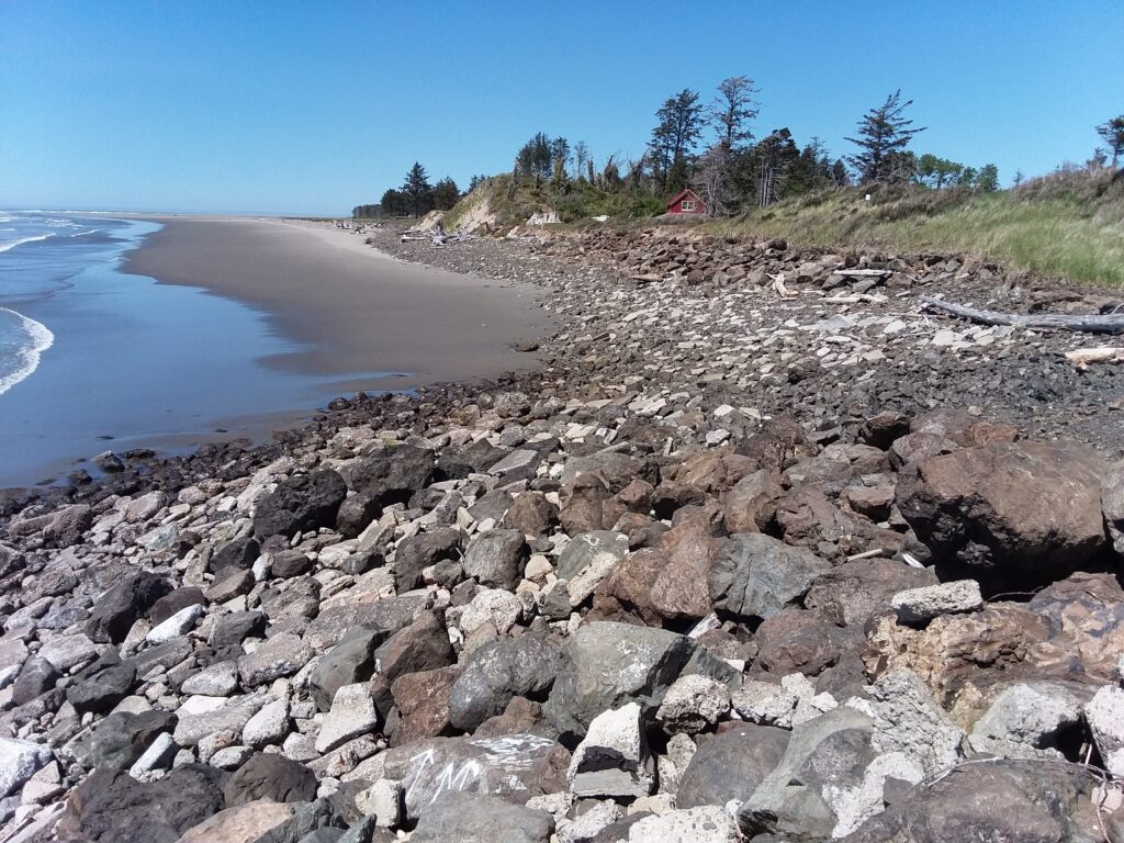 a rocky beach with a body of water in the background (MyCoast AI)