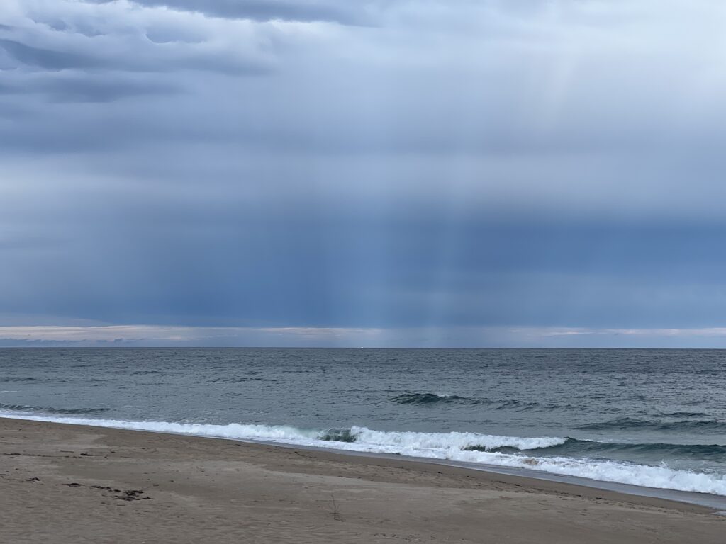 a beach with waves and clouds (MyCoast AI)