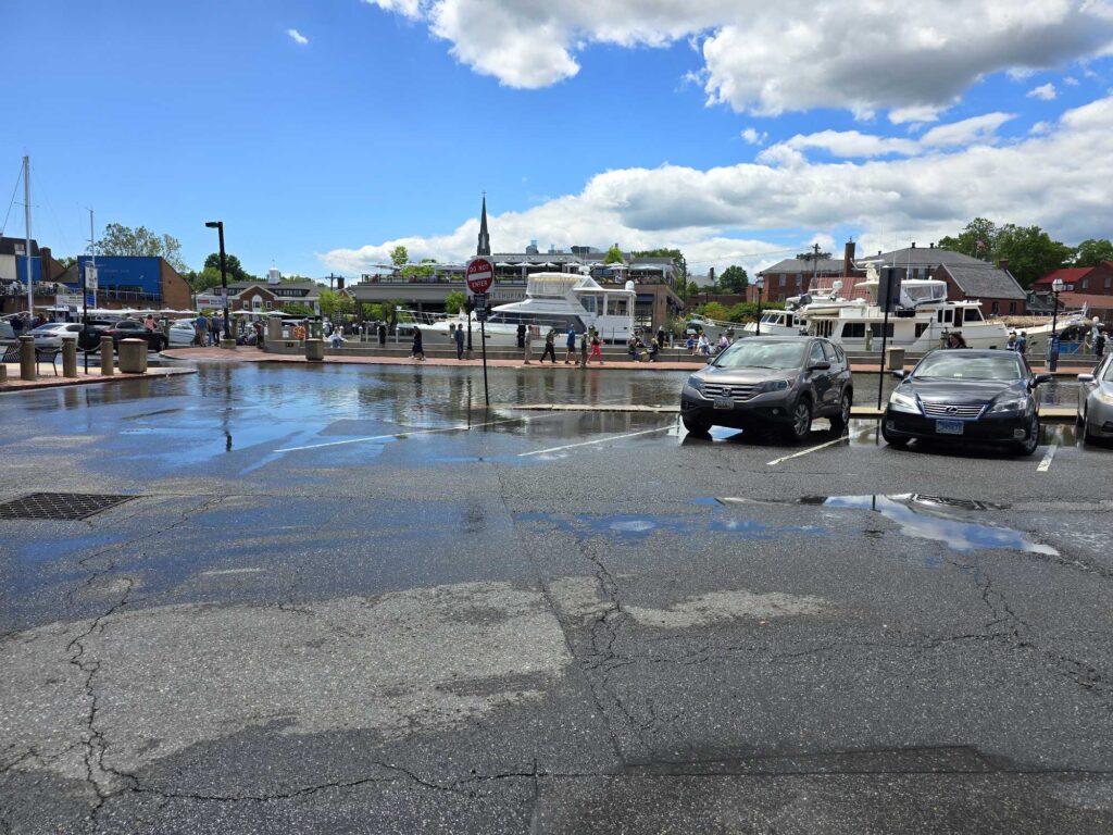 a wet parking lot with cars (MyCoast AI)