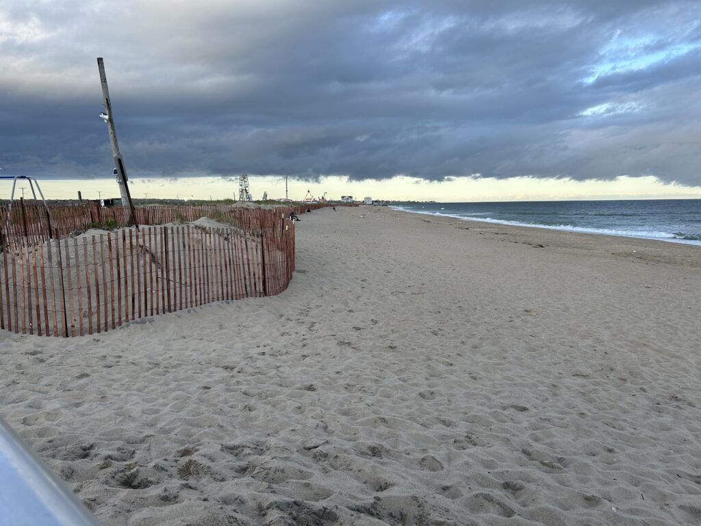 a sandy beach with a fence (MyCoast AI)