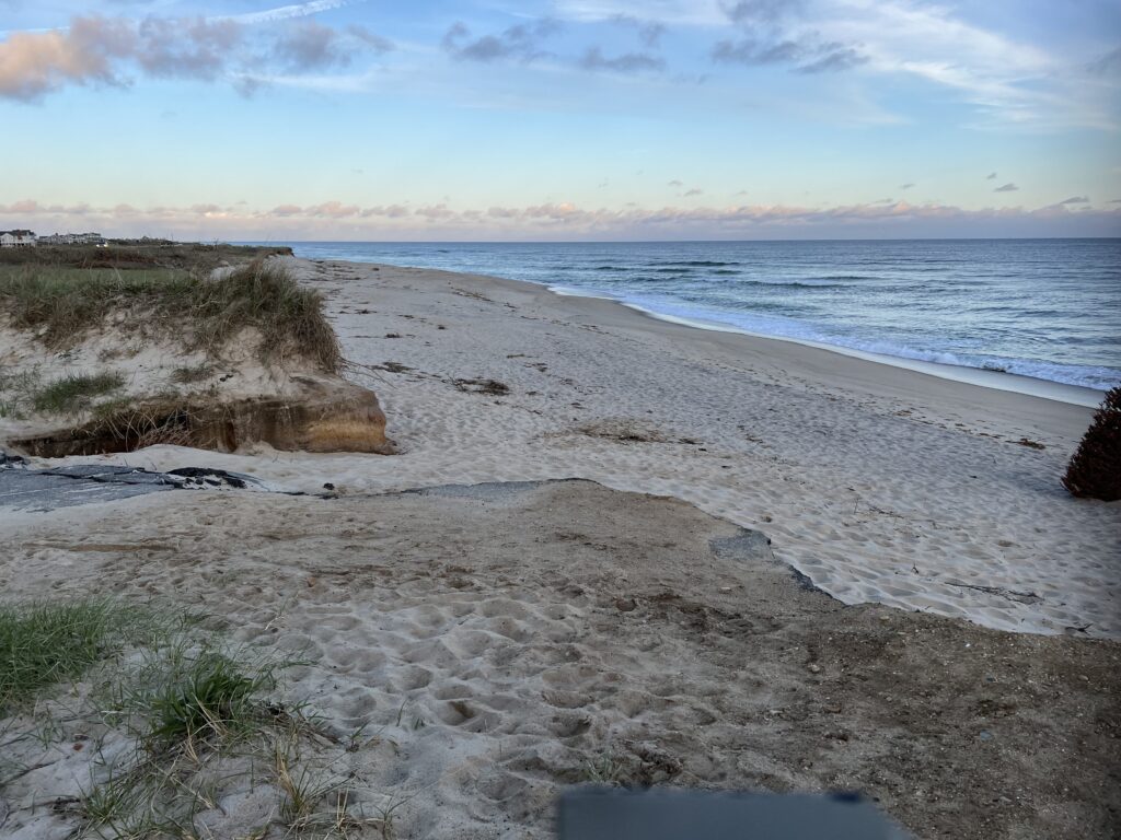 a sandy beach with water and rocks (MyCoast AI)