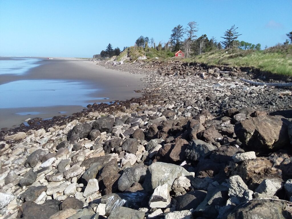 a rocky beach with a red house (MyCoast AI)