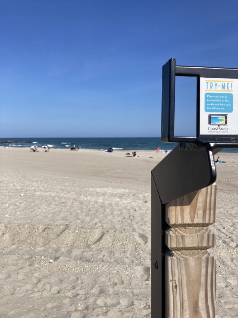 a sign on a beach (MyCoast AI)