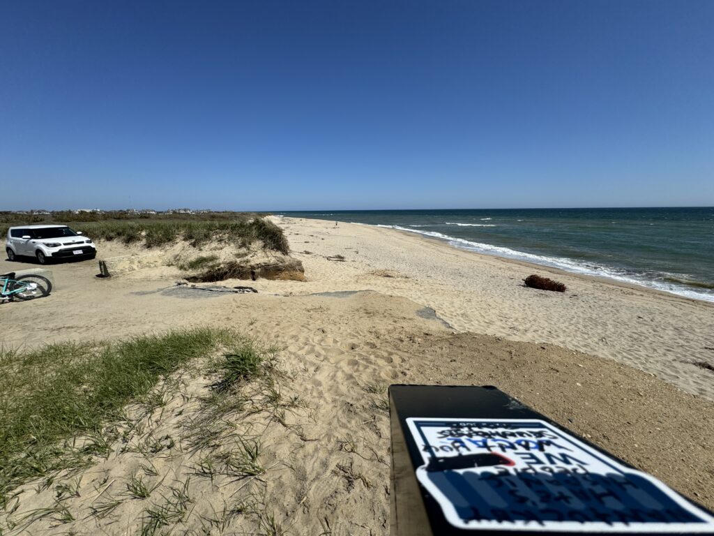 a sandy beach with a car parked on it (MyCoast AI)