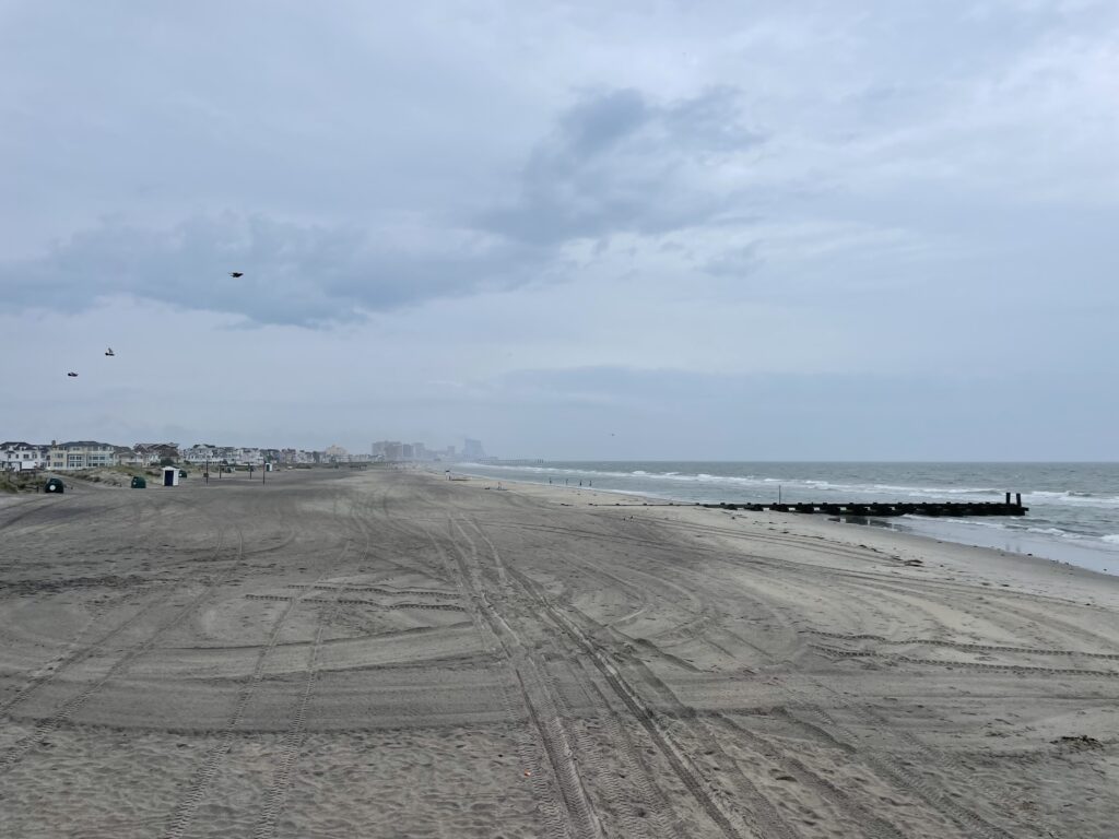 a sandy beach with waves crashing on it (MyCoast AI)
