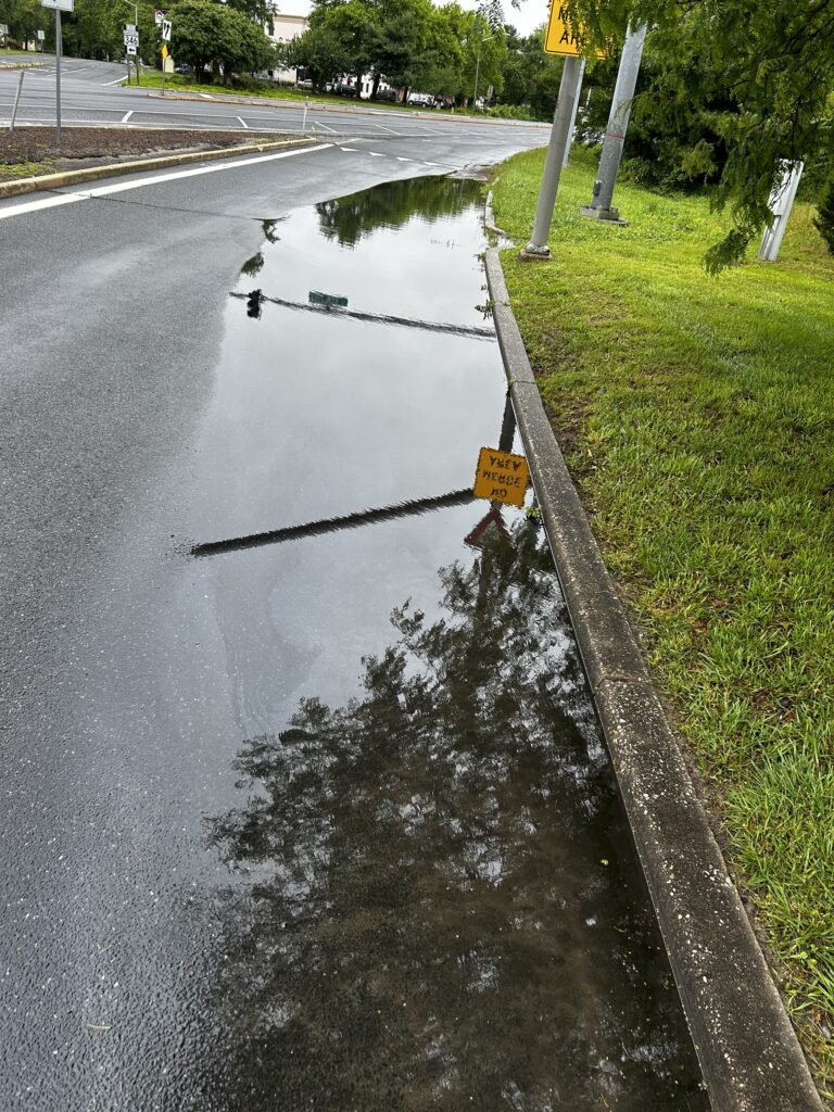 a flooded street with a sign (MyCoast AI)