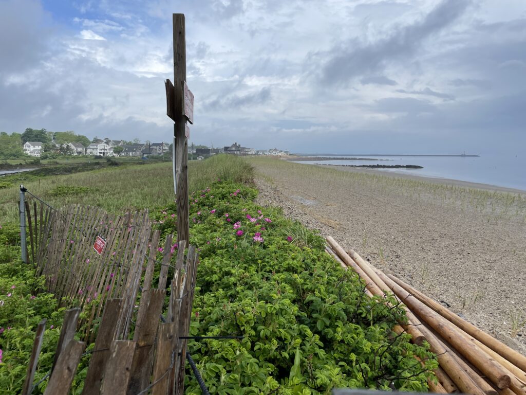 a fence next to a beach (MyCoast AI)
