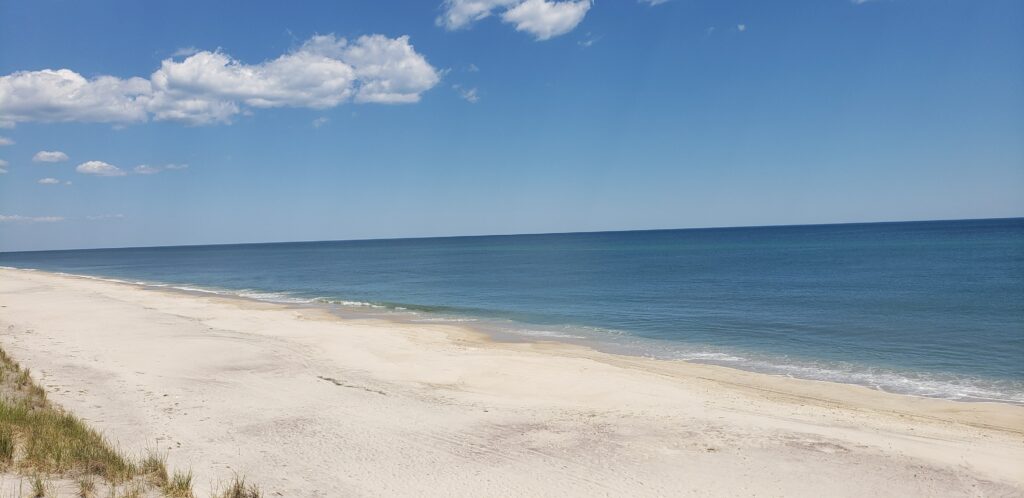 a sandy beach with blue water (MyCoast AI)