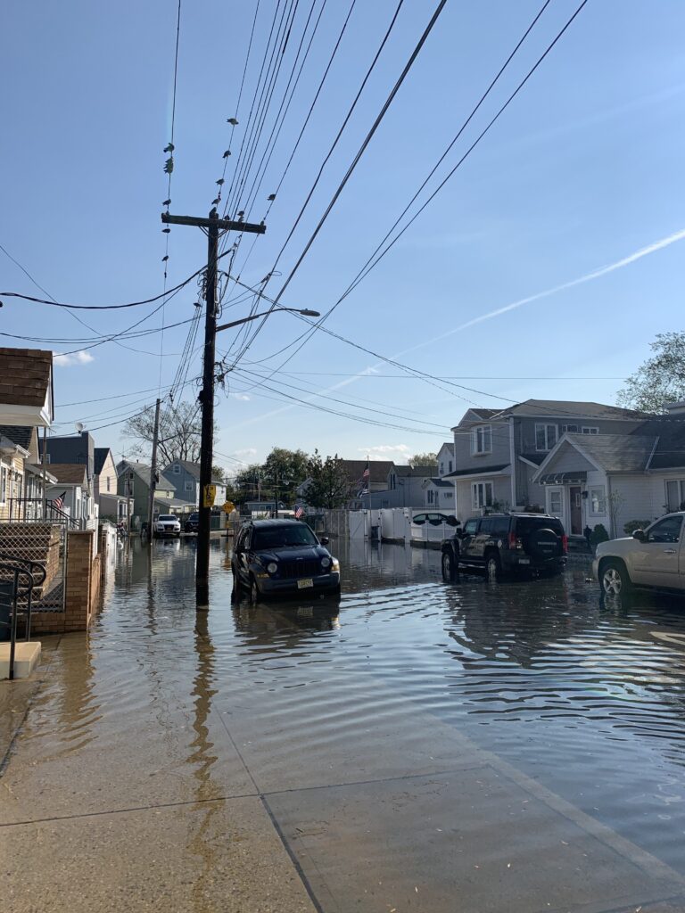 a flooded street with cars and houses (MyCoast AI)
