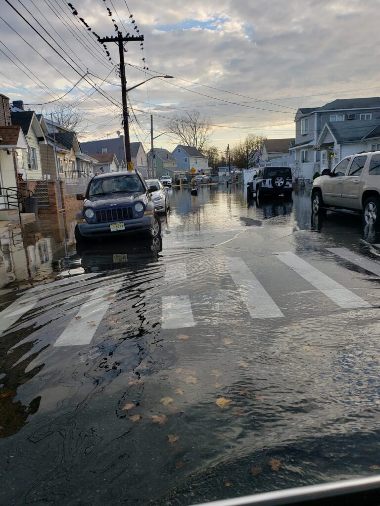 a flooded street with cars parked on the side (MyCoast AI)